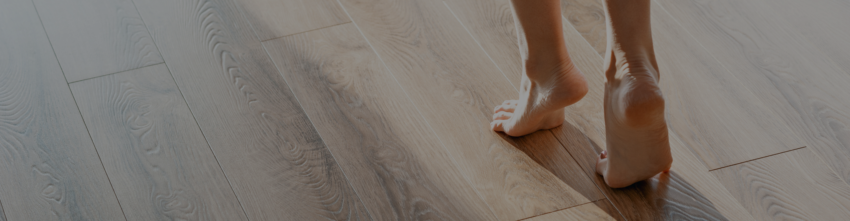 Luxury vinyl plank closeup with feet. 